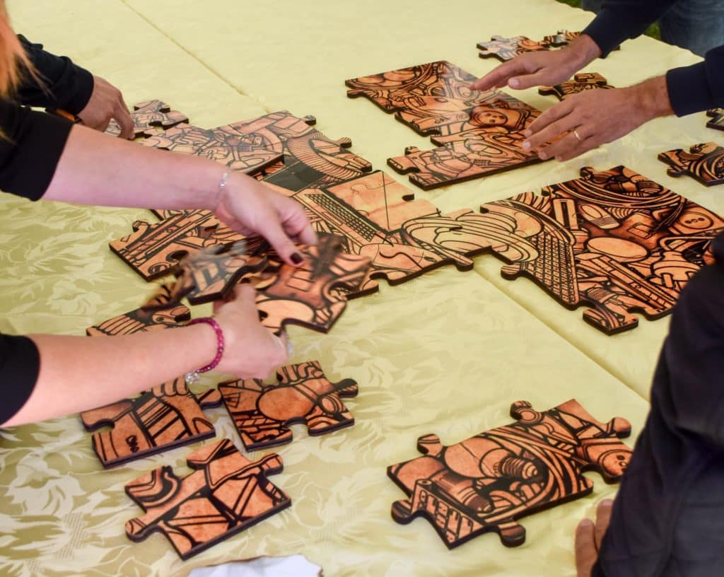 People doing a Puzzle during an Escape Game for Corporate Team Building